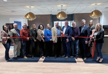Union Bank Board of Directors, employees and community members stand together to cut a grand opening ribbon.